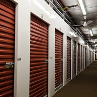 rows of red roll up doors in a climate controlled moving and storage facility