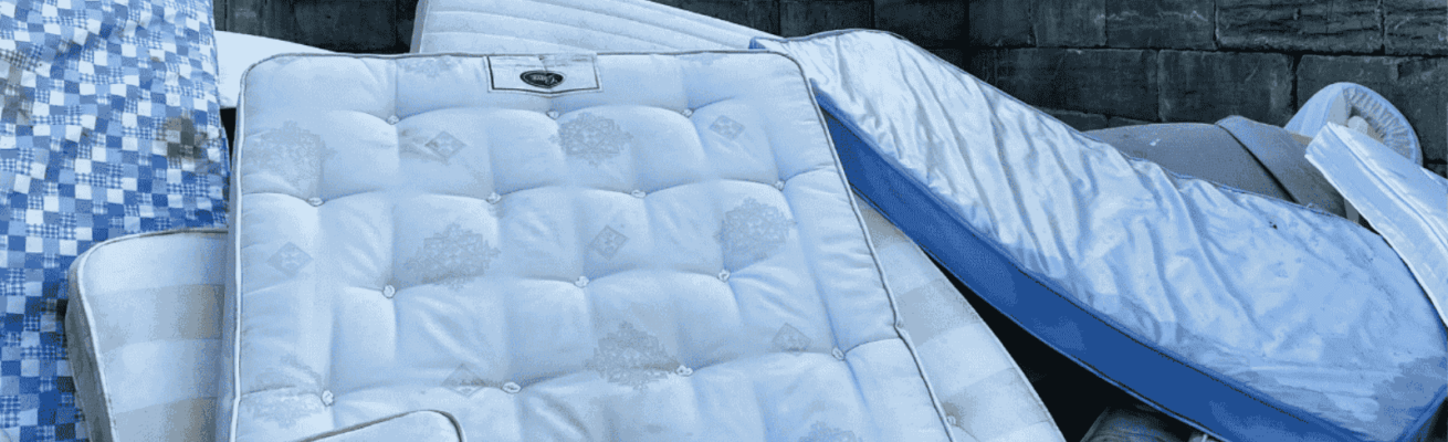 A pile of used mattresses for proper disposal