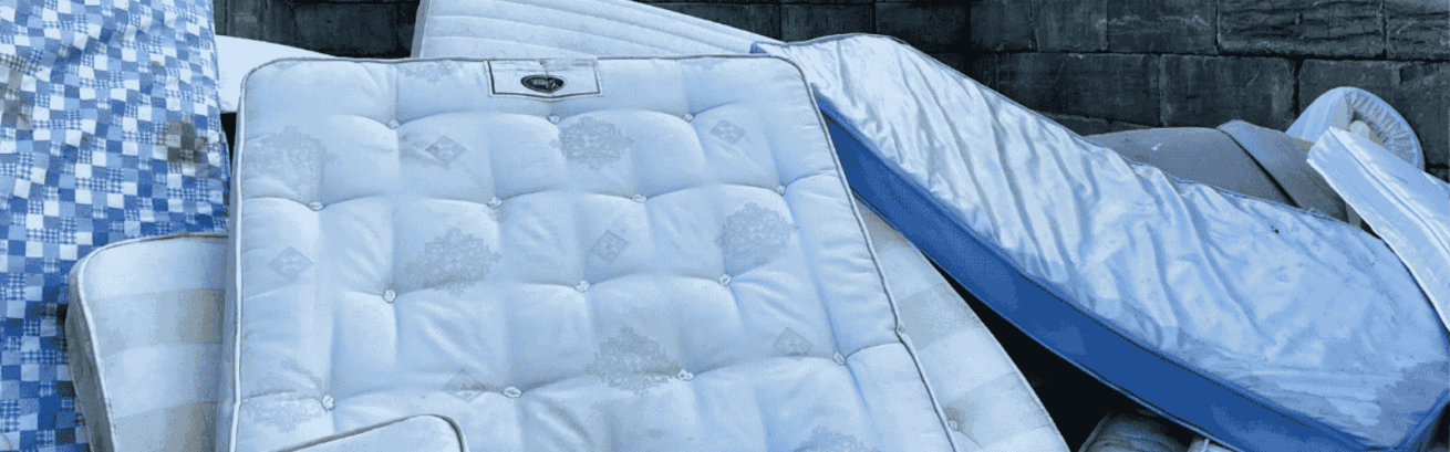 A pile of used mattresses for proper disposal