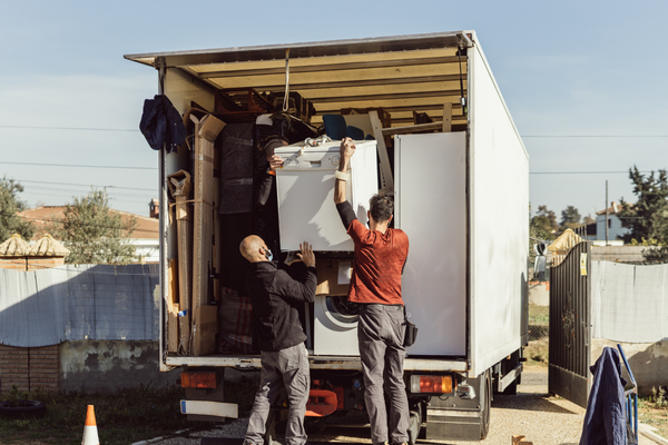 loading=junk-to-a-truck-mngmovers Two men loading junk to a truck