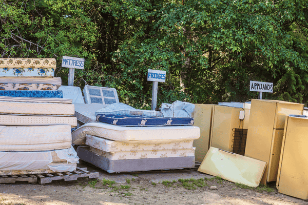 mattress-disposal-mngmovers matressses together with furnitures grouped and sorted for disposal