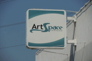 ArtSpace Herndon sign displayed on a white building wall, representing Herndon’s vibrant arts and local brewery community.