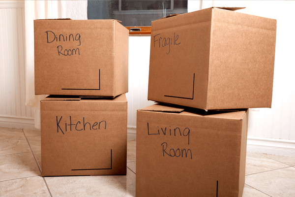 improper-disposal-of-mattress-mngmovers (2) Stack of labeled moving boxes for different rooms like kitchen, dining, and living room, showing how to organize and pack items efficiently when moving.